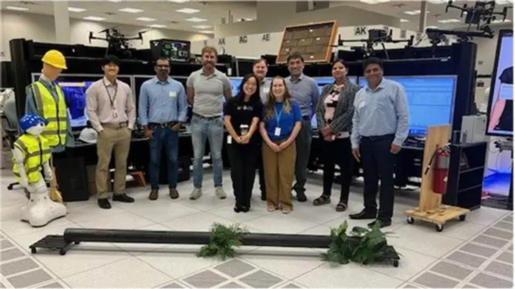 Practitioner team in a robotics and drone lab with industrial AI hardware